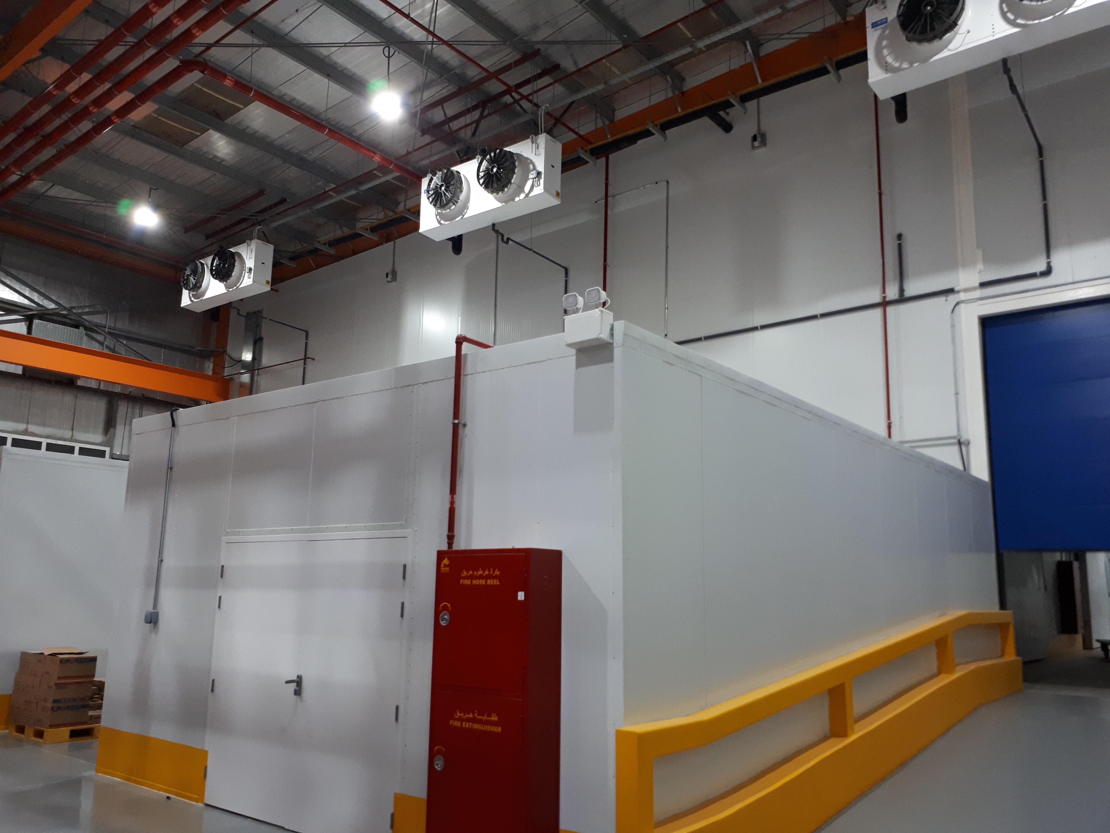 Project name: G2 International LLC, Technopark Dubai<br/>
Refrigeration contractor: Fanar al Khaleej Refrigeration<br/>
Execution: 2017-2018<br/>
Application: Logistic cold store, dry cold store, chiller and freezer cold rooms<br/>
Application with hot gas defrost + electrical in parallel<br/>
Cooling system description:<br/>
- Chilled receiving area: LU-VE Cubic 2# F50HC 1806 E 7 - 40,6kW  (10C_85%_EV-3) R404a<br/>
- 7 cold stores dual application Chiller/Freezer (various sizes): LU-VE Cubic 15# F50HC 1808 E 7 - 21,4kW (-20C_85%_EV-27C) R404a<br/>
- 2 cold stores dual application Chiller/Freezer (various sizes): LU-VE Cubic 4# F50HC 1806 E 7 - 17,4kW (-20C_85%_EV-27C) R404a<br/>
- 1 cold stores dual application Chiller/Freezer (various sizes): LU-VE Cubic 1# F45HC 1320 E 7 - 30,3kW (-20C_85%_EV-27C) R404a<br/>
- Corridor: LU-VE Cubic 2# F50HC 1706 E 6 - 40,6kW  (5_85%_EV-3) R404a<br/>
- Dry storage area (1800sqm): LU-VE Cubic 3# F71HC 4208 N 6 – 65,8kW (22C_65%_EV-27C) R134a<br/>
- Technical Store: LU-VE Cubic 1# F45HC 1112 N 4 – 28,9kW (22C_65%_EV-27C) R134a<br/>
- Plant room: LU-VE Cubic 1# F35HC 261 N 6 – 19,4kW (25C_65%_EV-27C) R134a<br/>
Rack System:<br/>
- 1# Profroid 200HP Rack for LT application R404a<br/>
- 1# Profroid 120HP Rack for MT application R134a
